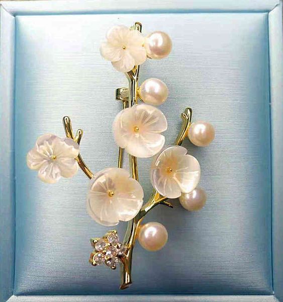 Exquisite minority-designed brooch featuring luxurious mother-of-pearl shell with elegant plum blossom motifs