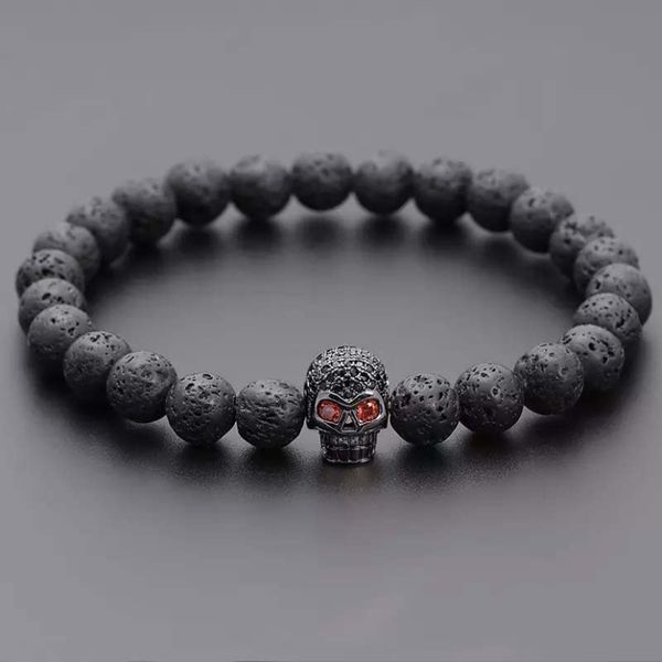 Faddish 8mm volcanic rock bead bracelet with zircon skull accents in black
