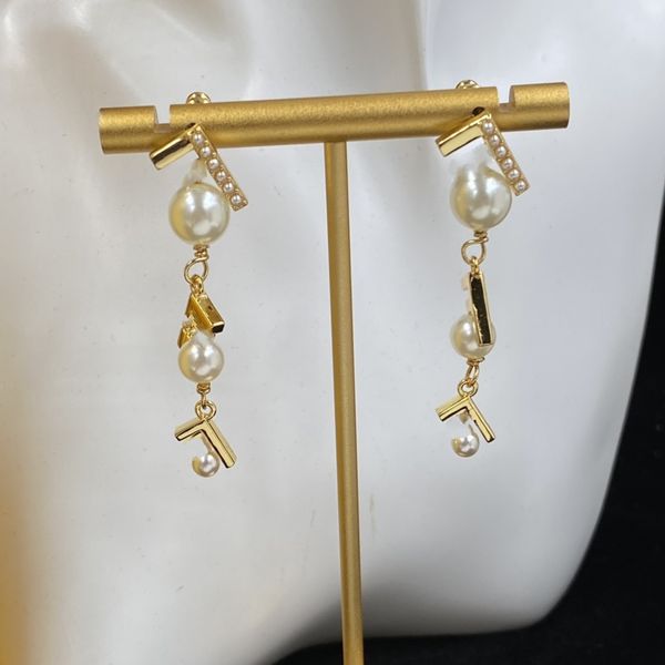 Fashionable designer letter stud earrings in luxurious copper for elegant women's party wear