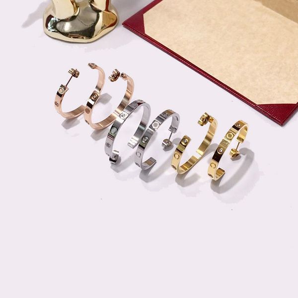 Fashionable diamond-accented titanium steel C hoop screw earrings for men and women, ideal as party or birthday gifts