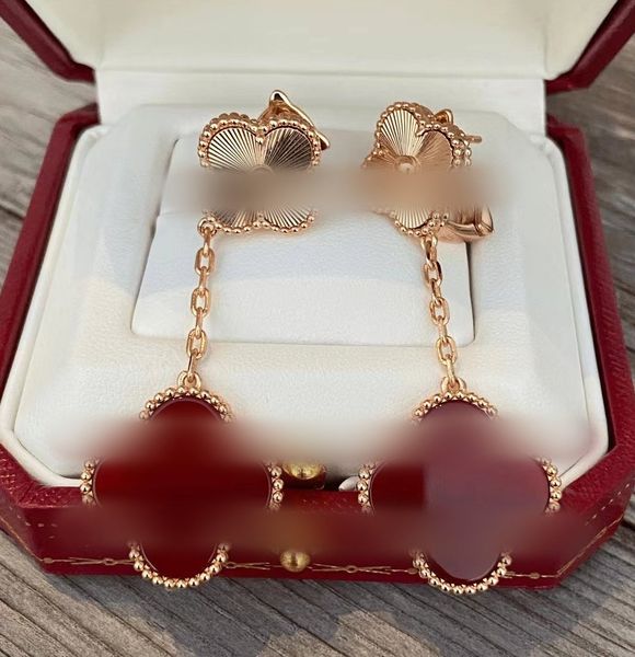 Fashionable four-leaf clover drop earrings with chandelier design, featuring brand letter V in gold and silver tones with red agate and mother-of-pearl accents for women