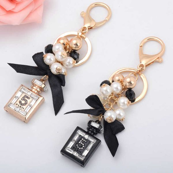 Fashionable keychain with decorative beads and bowknot design, perfect for women's bags or car keys as a stylish accessory or gift