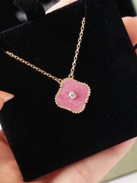 Fashionable pendant necklaces featuring a classic four-leaf clover charm in pink with diamonds, designed for women