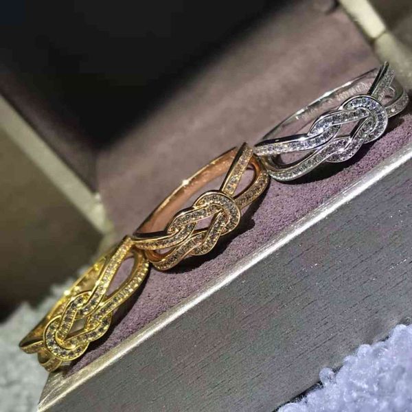 Fashionable U-shaped bangle bracelet with 8-word knot design, available in wide and narrow versions featuring full or half diamond accents, offered in silver-plated or 18k rose gold as a pair
