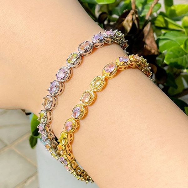 Fashionable women's designer bracelet with colorful AAA cubic zirconia charms, 18k gold plating, and purple crystal accents in a copper bangle style