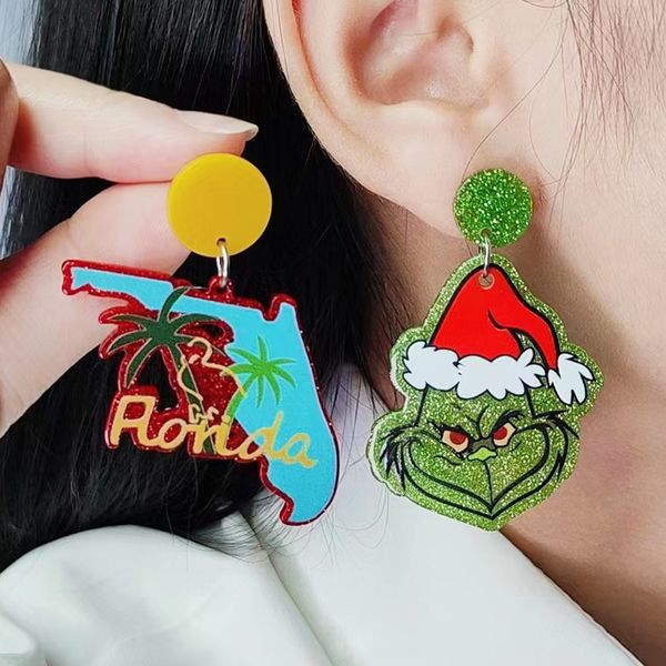 Festive stud earrings for women featuring red and green geometric designs with coconut tree, heart, HOHOHO letter, Grinch, and Santa Claus dangle charms