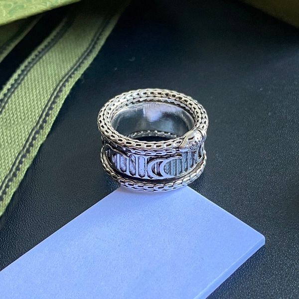 Glistening ring featuring chain-like patterns and symbolic motifs, crafted with exquisite skill as a stylish high-end jewelry accessory
