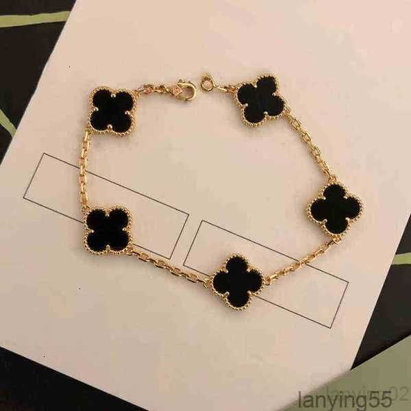 Gold charm bangle bracelet with four-leaf clover, agate, shell, and mother-of-pearl accents for women and girls, perfect for weddings