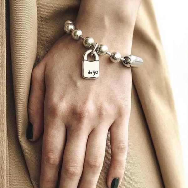 Gold lock pendant beaded bracelet, a trendy fashion accessory for women