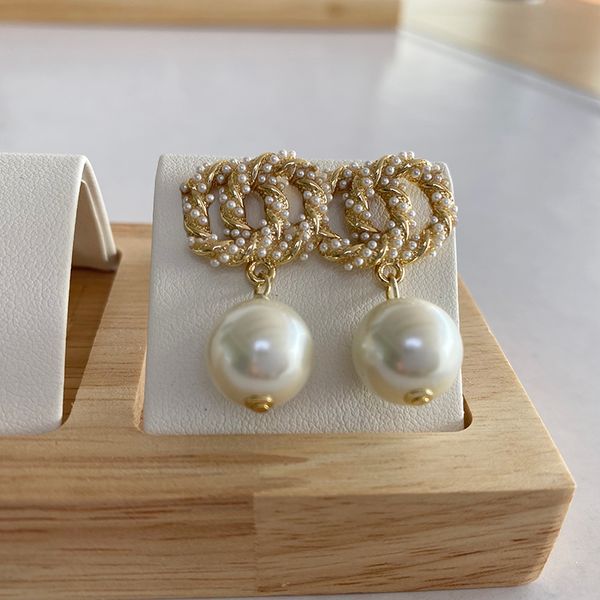 Golden small pearl earrings with diamond drops in gold or silver, stylish designer women's fashion jewelry perfect for weddings and branding