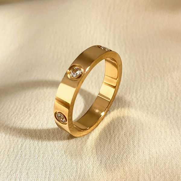 Gold-plated women's wedding ring with diamond accents in titanium steel, featuring classic gold and silver rose designs
