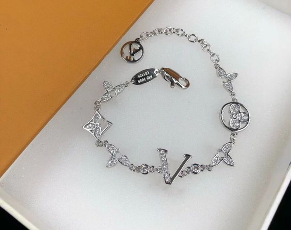 Handcrafted elegant gold and silver bracelet for women featuring letter pendants and clover designs, perfect for weddings and special occasions
