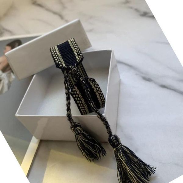 Handmade designer cotton bracelets for men and women, featuring signature embroidery on woven fabric bangles, presented in white boxes