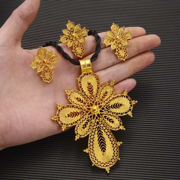 High-quality 14k gold Ethiopian jewelry set featuring a large cross necklace, earrings, and ring, perfect for Dubai brides, Habesha culture, and African-inspired gifts