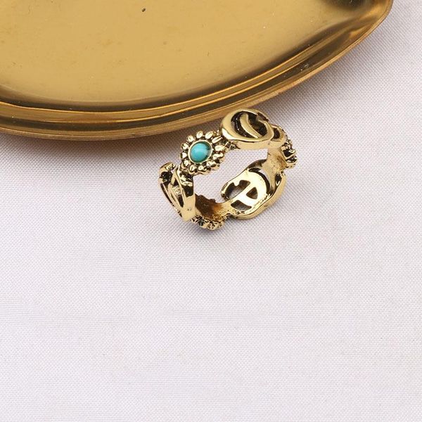 High-quality 18K gold-plated letter band rings for men and women, featuring designer brand letters with turquoise crystals and daisy metal jewelry
