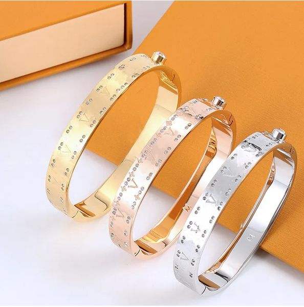High-quality luxury bangle bracelet featuring a 4-leaf flower design and letter accents, crafted from titanium steel with diamond embellishments, a stylish jewelry gift for women and men
