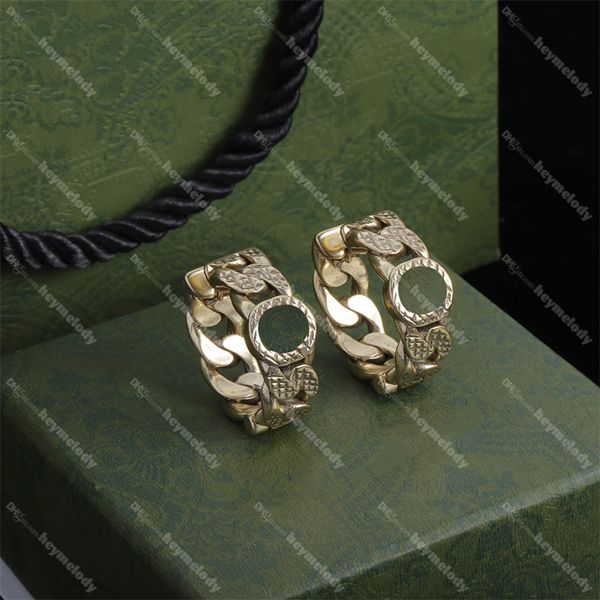 Interlocking gold horseshoe stud earrings with double G design and seal detailing