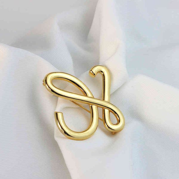 Luo ethnic-inspired geometric openwork brooch with stylish cold metal finish, a versatile fashion accessory