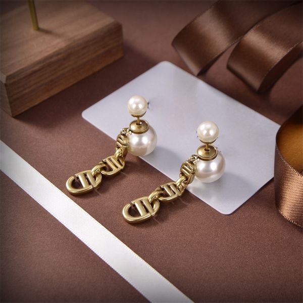 Luxurious brass letter chain earrings featuring double-sided pearl accents