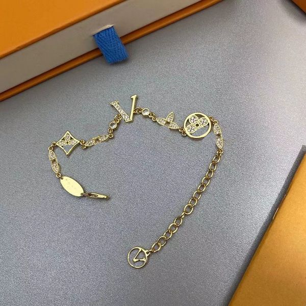 Luxurious designer bracelet for women featuring elegant gold and silver tones with letter pendant and clover charm, perfect for weddings and special occasions