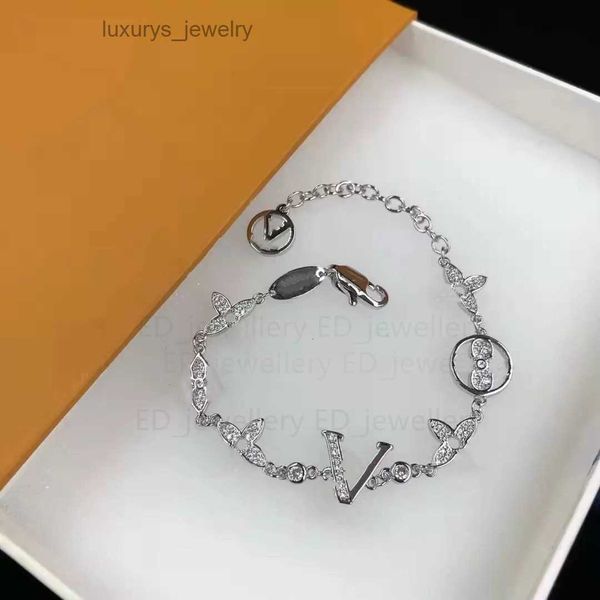 Luxurious designer jewelry featuring elegant gold and silver bracelets with letter pendants and clover charms, perfect for weddings and special occasions