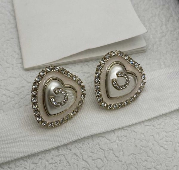 Luxurious heart-shaped drop earrings featuring natural shell beads and diamonds in 18k gold plating, stamped PS6119 with included box