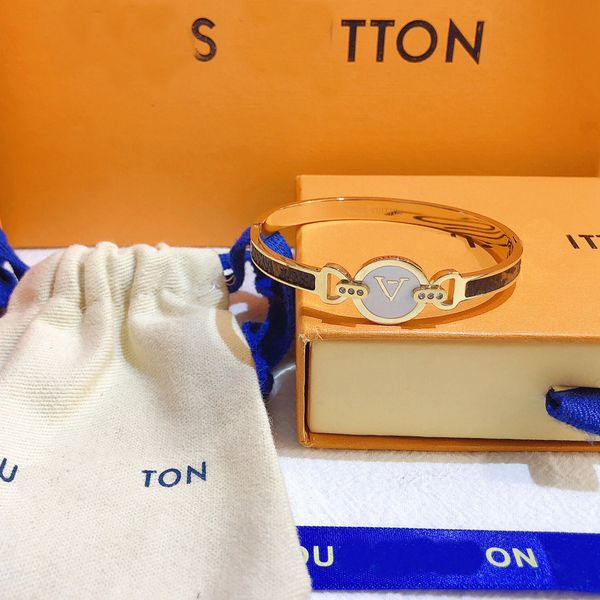 Luxurious monogram-embossed leather bangle bracelet for women, featuring 18k gold plating and stylish brand lettering