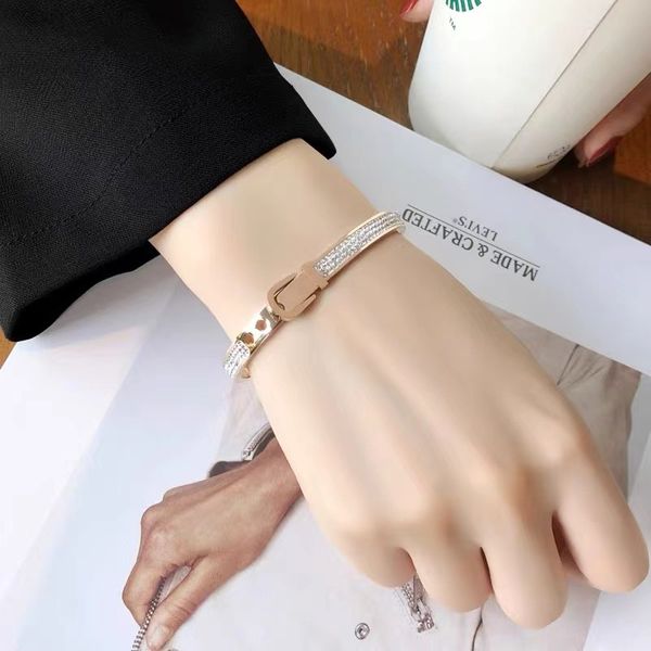 Luxurious rose gold bangle bracelet with diamond accents, perfect as a women's engagement gift