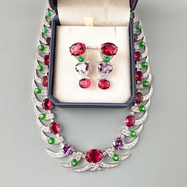 Luxurious women's jewelry set featuring red and purple cubic zirconia, imitation ruby, and gold-plated green bead designs in earrings and necklaces