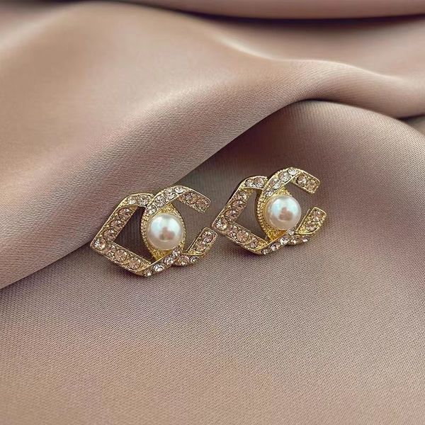 Luxury designer women's stud earrings with multi-color 18k pearl accents, perfect as wedding gifts