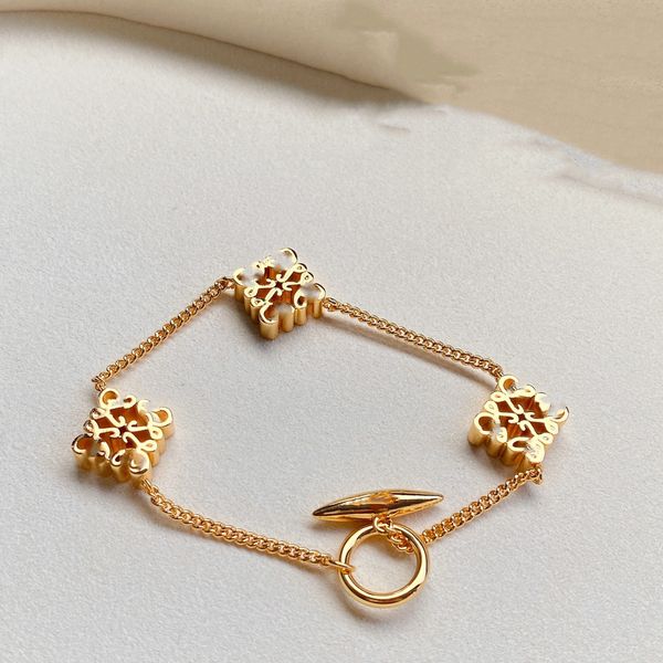 Luxury hollow L-shaped bracelet for women, featuring a gold letter pendant, part of a classic brand set, ideal as an elegant dress accessory in 18k gold