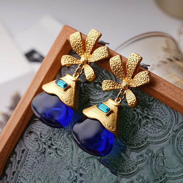 Medieval-inspired gold floral ear studs with vintage blue-green crystal gems