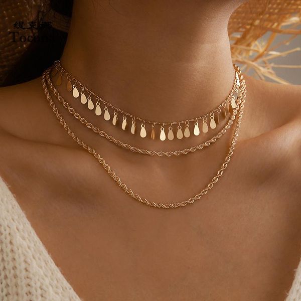 Punk-style layered pendant necklace featuring leaf tassels and gold alloy chains, a bohemian-inspired women's jewelry gift