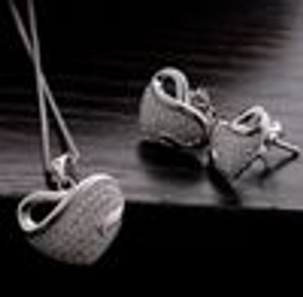 Rhodium-plated silver heart pendant necklace with matching earrings, adorned with clear crystal rhinestones