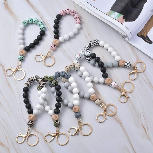 Silicone keychains featuring leopard-printed wooden beads in multicolor, designed as stylish jewelry for women