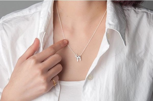 Simple small elk antler pendant necklace with deer clavicle, featuring reindeer horn and woodland fawn charm jewelry