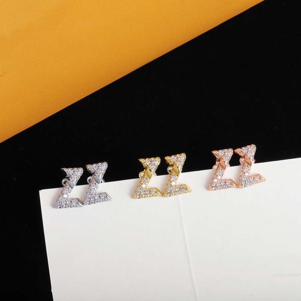 Stainless steel gold-plated designer earrings featuring a simple letter V hoop with crystal inlays, ideal for weddings