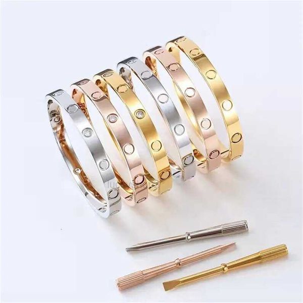 Stylish steel cuff bracelets with screw details for women and men, featuring luxury designer bangles and a screwdriver