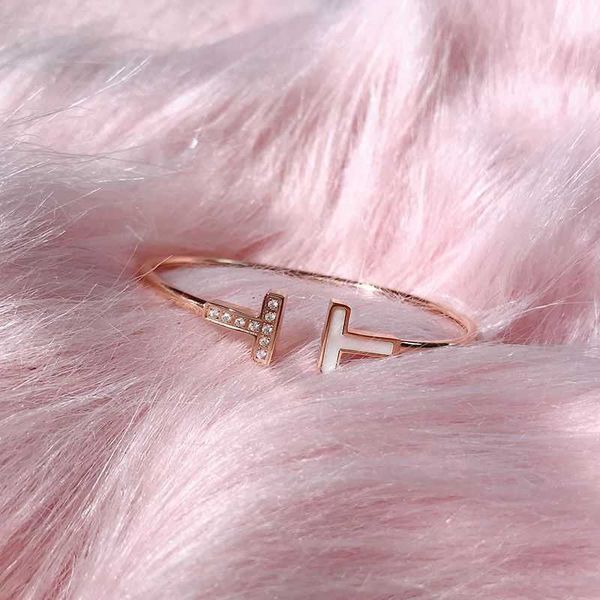 Stylish T bangle bracelet in sterling silver with rose gold accents, featuring white fritillaria diamonds, a versatile open design perfect for gifting