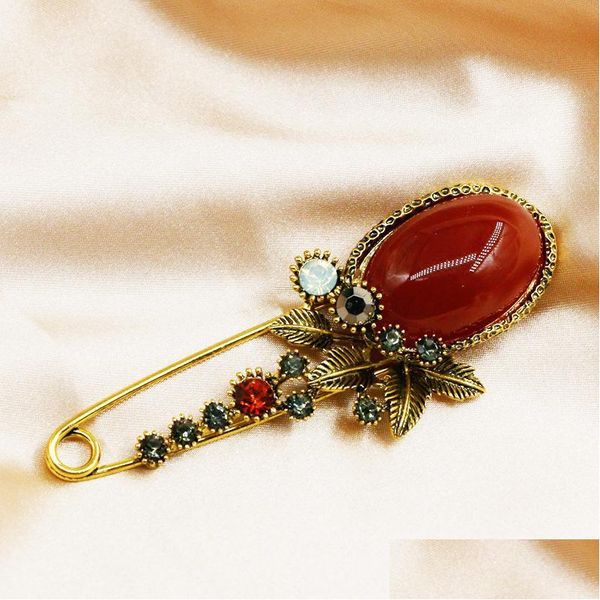 Vintage ruby brooch for women with golden antique design, featuring sier crystal rhinestone and metal jewelry accents