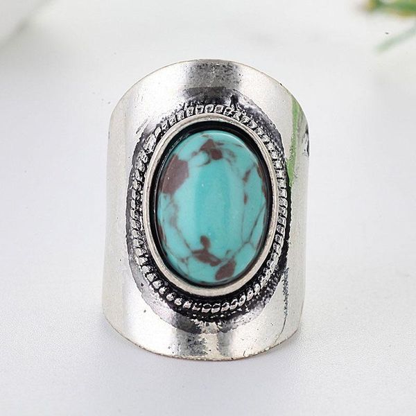 Vintage Tibetan-inspired silver ring with green resin stone and carved floral design for women's parties