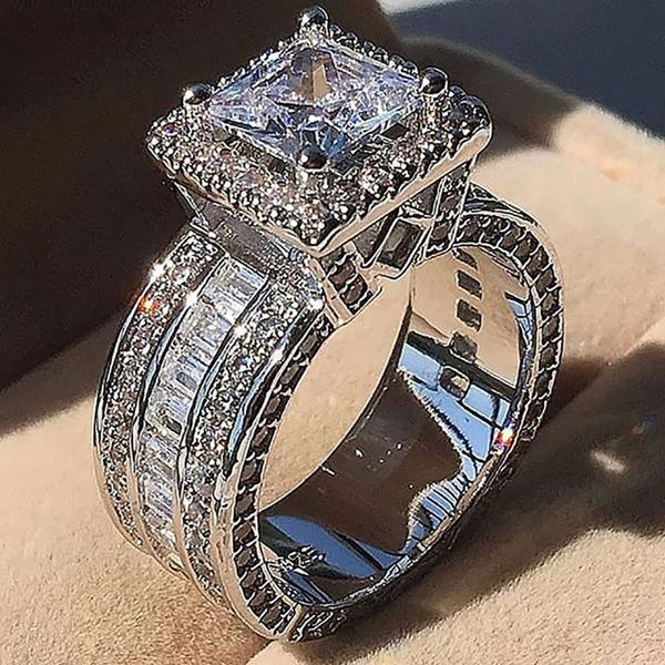 Vintage-inspired sterling silver ring with princess-cut CZ stones, perfect for men's engagement or women's wedding jewelry gifts
