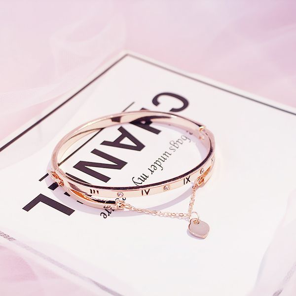 Wholesale rose gold stainless steel heart charm bracelets for women, featuring a forever love design from a renowned jewelry brand