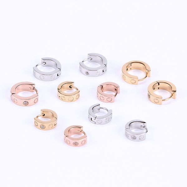 Woman's stylish open ear studs featuring elegant letter designs, perfect for hip hop fashion with titanium steel and diamond accents
