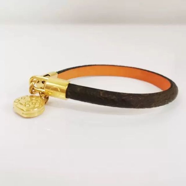 Women's brown leather bracelet with vintage floral charm and gold-tone accents, a stylish jewelry accessory for both genders, available wholesale