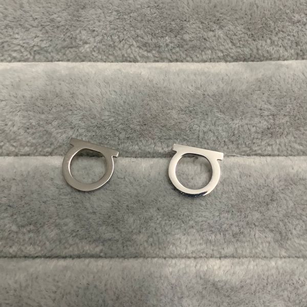 Women's designer stud earrings in gold and silver, featuring a simple, smooth surface for a classic and luxurious look, available for wholesale