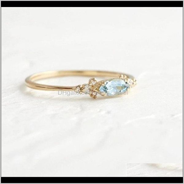 Women's jewelry set featuring aquamarine rhinestone rings with side stones, gold-plated for a stylish engagement look
