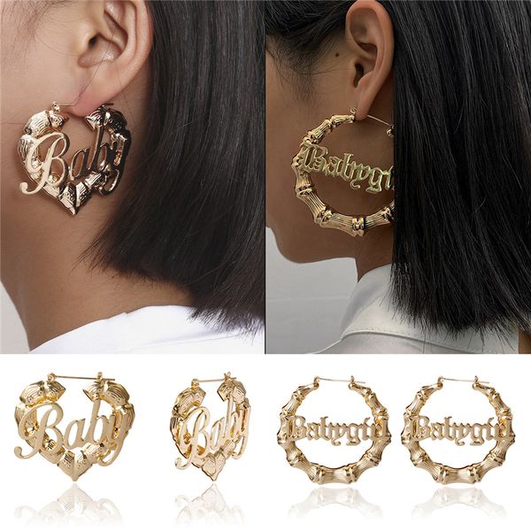 Women's stylish gold hoop earrings featuring baby girl letter charms, silver love accents, peach heart details, geometric circle patterns, bamboo and bone elements for a bold fashion statement